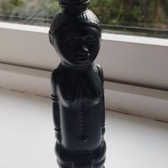 Vintage miniature "VUDU" bottle made of opaque black glass.