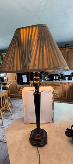 Vintage ebonized table lamp featuring an octagonal base, likely dating from the early 20th century.