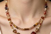 Handmade beaded necklace in warm amber, red and gold tones