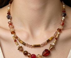 Handmade beaded necklace in warm amber, red and gold tones