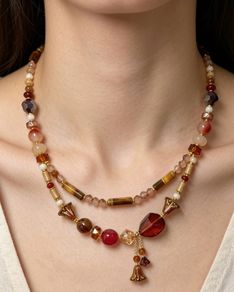 Handmade beaded necklace in warm amber, red and gold tones