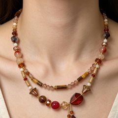 Handmade beaded necklace in warm amber, red and gold tones