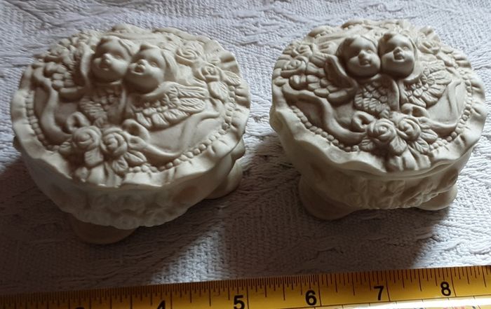 two vintage cherub pots with lids