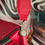 Red crossbody bag, adjustable shoulder strap. Image 3