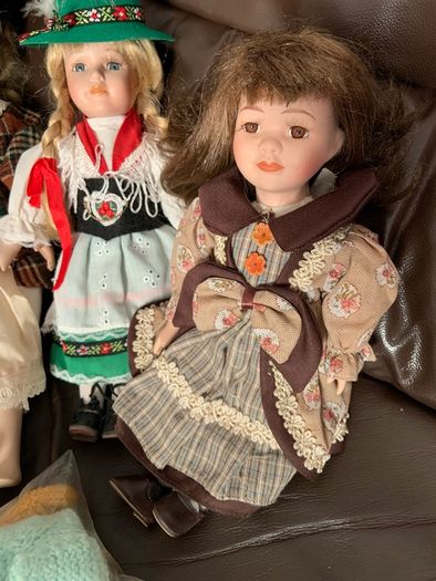 5 porcelain dolls with extra clothing perfect condition