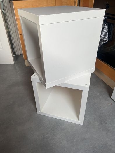 2 white storage units or bedside tables