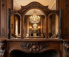 This is a massive old inlaid wooden framed triple arched mirror.