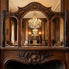This is a massive old inlaid wooden framed triple arched mirror.