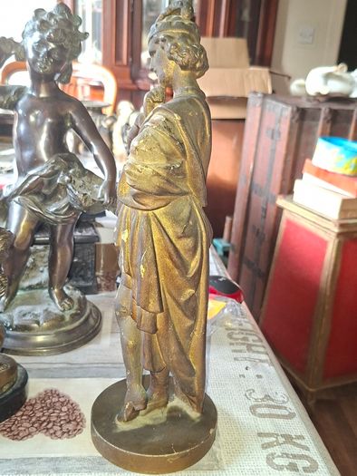 Antique Sculpture a gilt-bronze cast-metal Spanish Conquistador. On his torso is a Cross Pattee, a historical motif commonly associated with Christian military orders and medieval heraldry