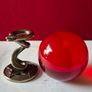 Red crystal/glass ball and metal serpent stand. Image 4