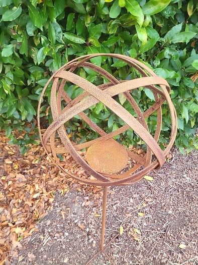 Corten steel garden sphere on a stem