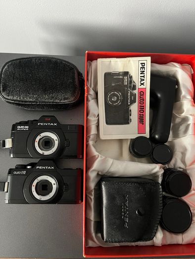 3 Pentax Auto 110 film cameras and accessories boxed