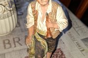 Old Painted Terracotta of a Young Country Boy Holding a Flute, standing on a rocky base. It resembles late 19th- or early 20th-century European decorative sculptures, such as pieces produced by makers like Goldscheider