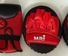 2 USI Universal boxing gloves and pads, unused.