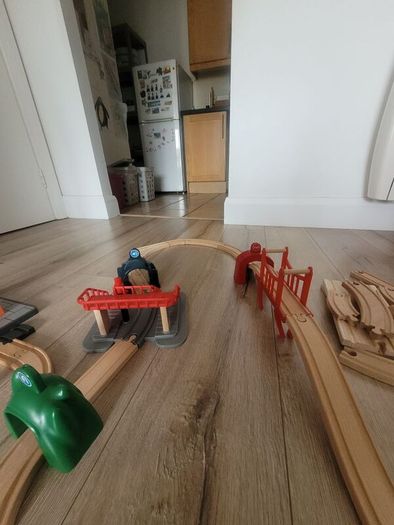 wooden train play set with two electric locomotives and lots of parts