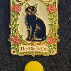 The black cat , pin back badge.