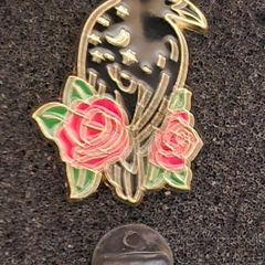 Raven and rose, pin back badge.