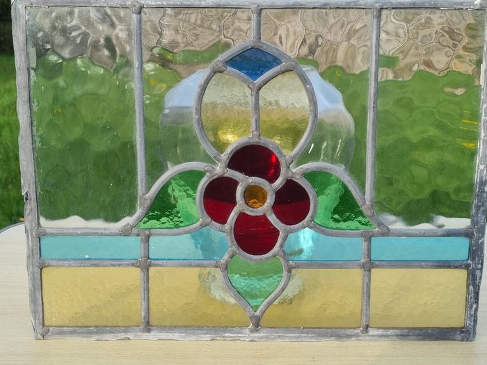 Antique leaded stained-glass panel in the Art Nouveau style.