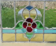 Antique leaded stained-glass panel in the Art Nouveau style.