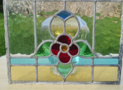 Antique leaded stained-glass panel in the Art Nouveau style.