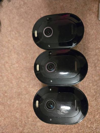 Arlo Pro 4 three cameras, a base station, solar panels