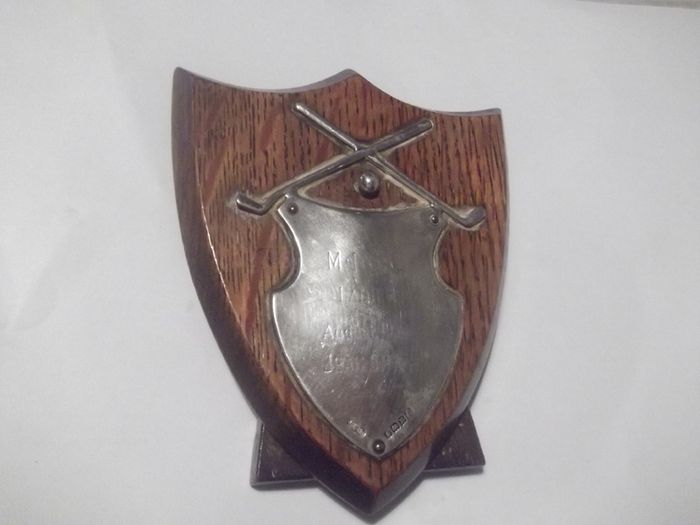 a small antique silver  golf plaque