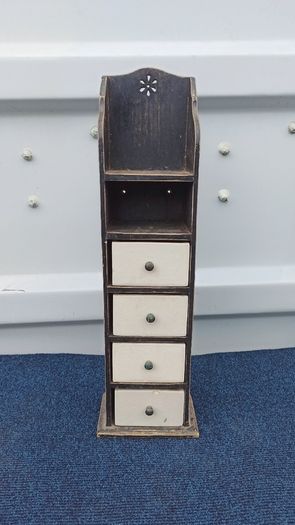 Small vintage wooden storage unit with heavy ceramic drawers with brass knobs
