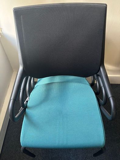 Office chairs with black frames and teal seats