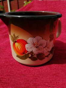 Retro Mid Century Milk pot or jug.  Enamel dark brown and orange with a floral pattern!