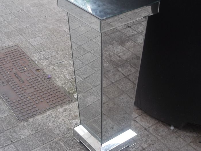 a shops display stand with mirror all round it