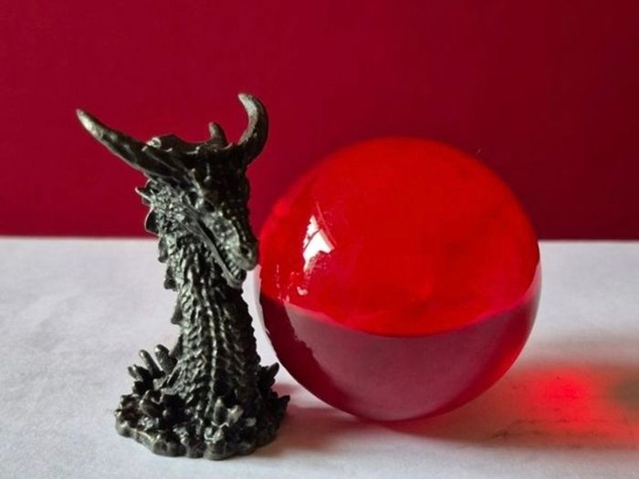 Red crystal/glass ball and metal dragon stand.