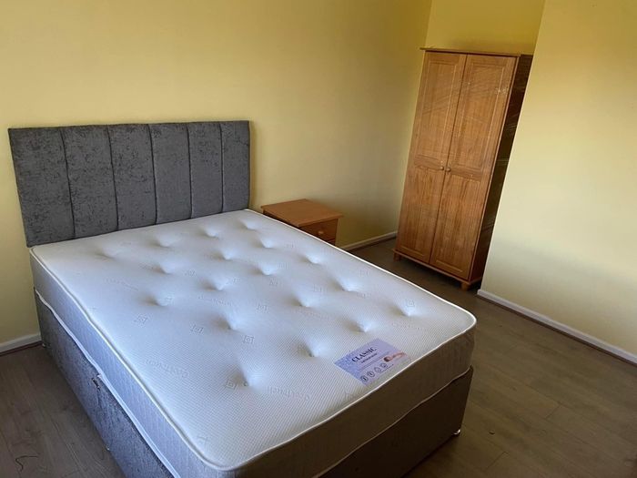 Grey double bed with mattress