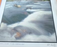 Framed Photograph art print depicting a rushing stream or waterfall, labeled -Glendalough - Co Wicklow- and hand-signed by the artist by Michael Walsh.