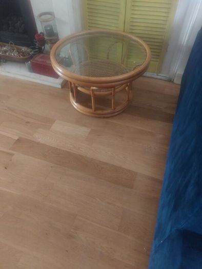 Round wicker coffee table with glass