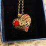 Heart-Shaped Pendant Necklace with Red Glass Heart and Wing Details Image 3