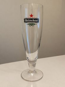 Set of 4 matching vintage Heineken stemmed beer glasses.