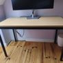 Modern desk with light wood top and black metal frame Image 4