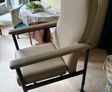 Adjustable high backed chair for an elderly person