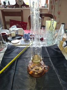 Beautiful Old Glass Thumb Oil Lamp It features a Tall Slender Glass Chimney designed to protect the flame and improve combustion Postage Available