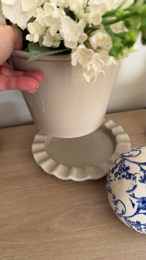 Beige pot with faux flowers