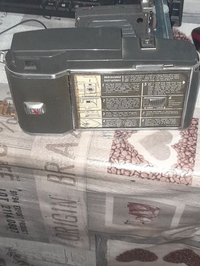 Vintage Large Polaroid Electric Eye Land Camera Model 900, Manufacture between 1960 and 1963. Key Features: Top of the line automatic shutter model featuring a folding bellows design and electric eye light metering