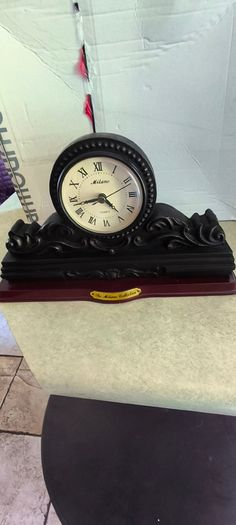 Vintage Bronze-toned Table Clock - Quartz Movement with Wooden Base by The Milano Collection in working order.