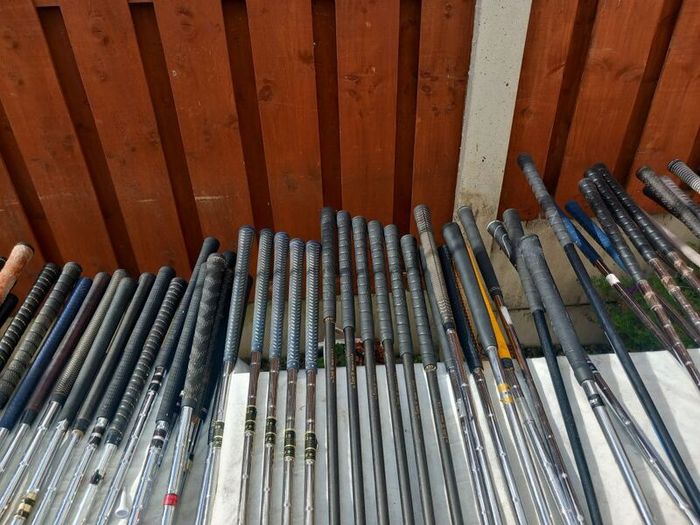 A selection of Golf clubs. Bags and golf balls.