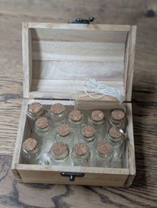 Wooden box with vials and paperbags