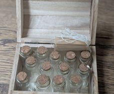 Wooden box with vials and paperbags