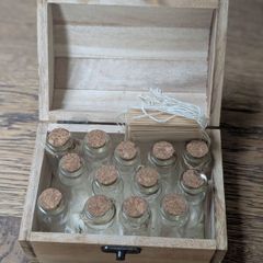 Wooden box with vials and paperbags