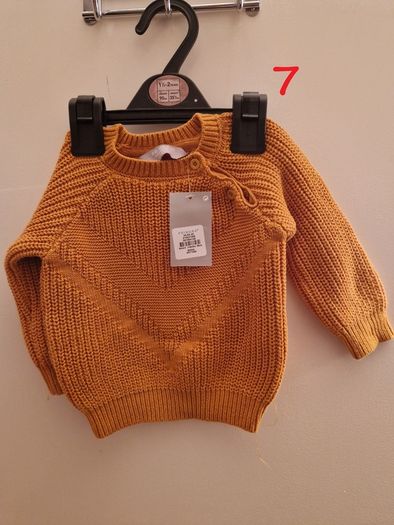 A selection of brand new baby clothes and items