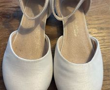 White satin occasion shoe with ankle strap and low heal
