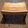 Vintage footstool which has wooden legs. Image 2
