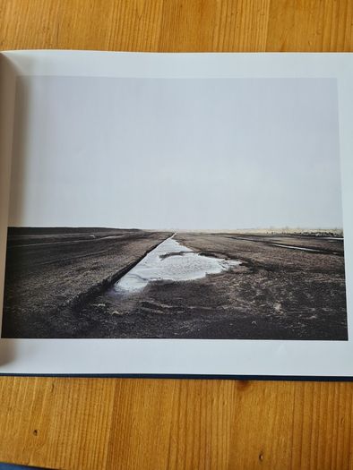 Under A GREY Sky. By Simon Burch. This Book Of Photos  Follows The landscape,people, & Towns Affected By The Collaps Of Board Na Mona's Peat Mining  Industry. IN IRELAND.